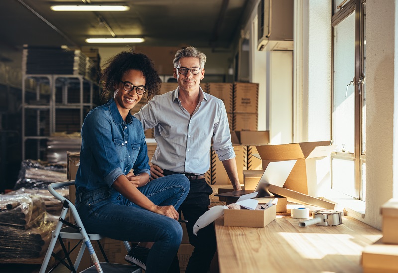 Man and woman entrepreneur working in a warehouse