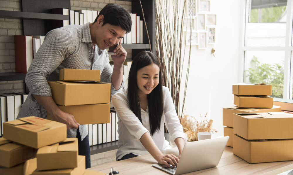 Entreprenuers checking orders and packing them in their warehouse