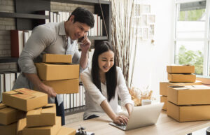 Entreprenuers checking orders and packing them in their warehouse